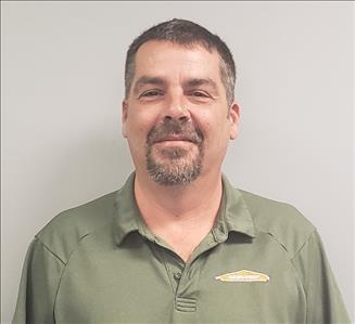 male employee with brown hair wearing a green SERVPRO shirt
