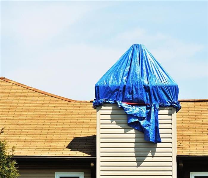 blue tarp covering chimney